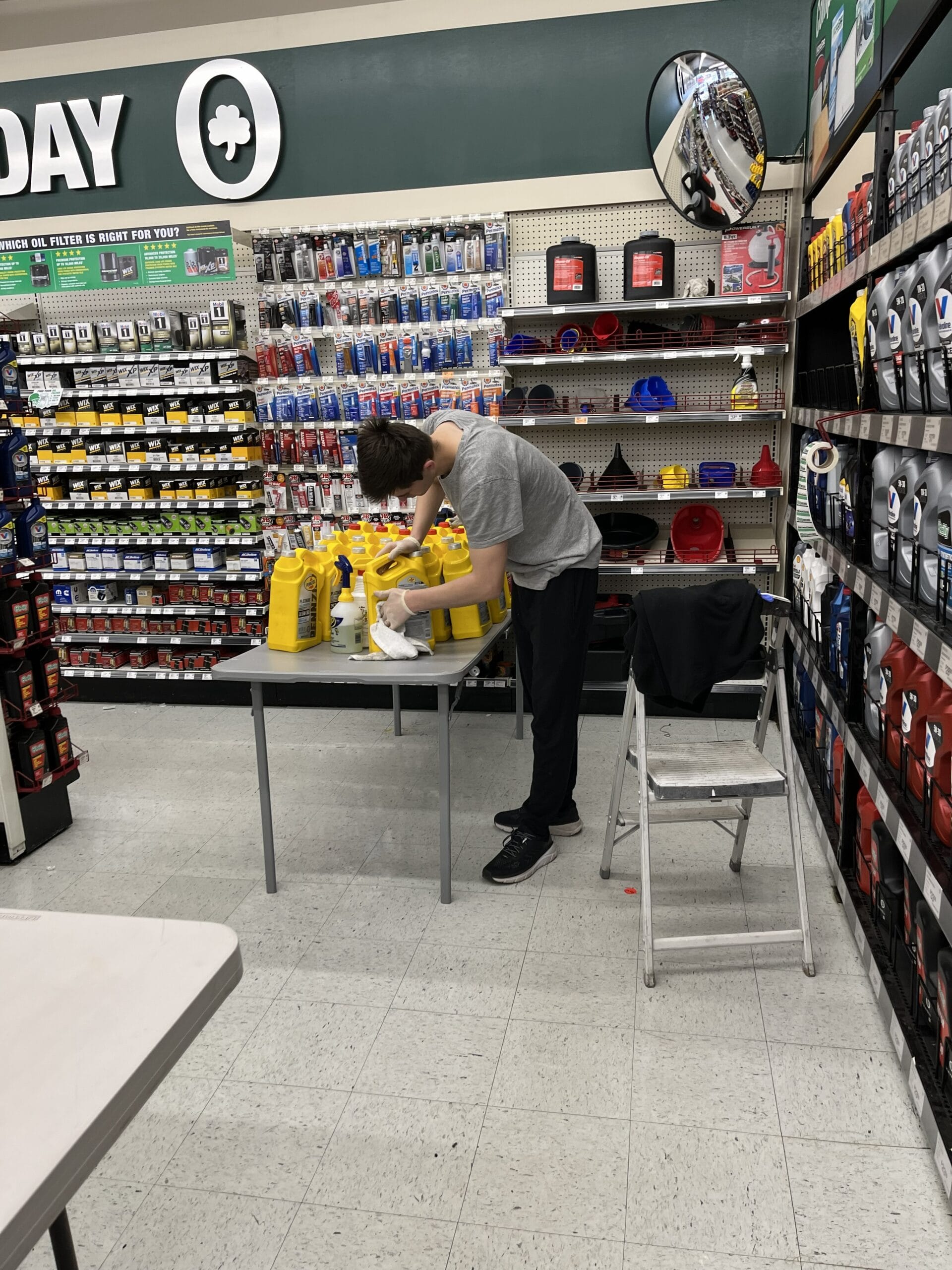 Commercial cleaner wiping retail product displays and merchandise